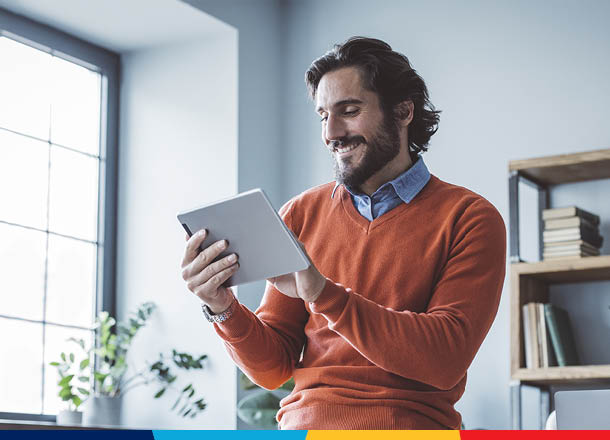 Smiling man holding tablet
